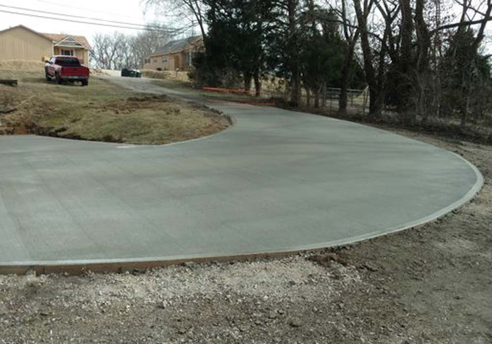 Curved concrete driveway installation at a residential home in Liberty, MO